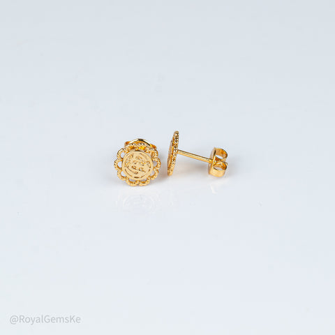 A pair of gold stud earrings shown on a clean white background, with one earring displaying the front floral face and the other showing the side profile with post and backing.