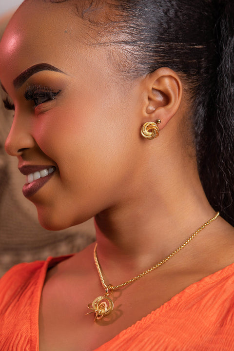 Woman wearing gold jewelry with a blurred background