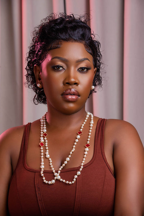 Woman wearing a pearl necklace with a blurred background