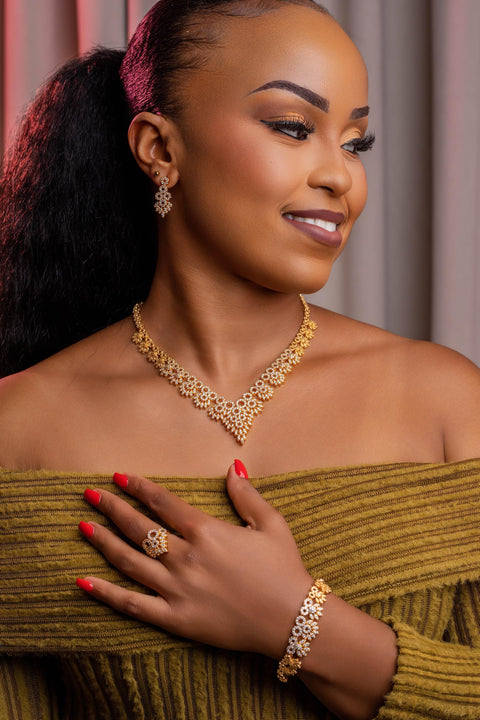 Woman wearing gold jewelry against a neutral background