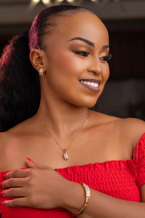 Woman wearing a red dress with jewelry, smiling.