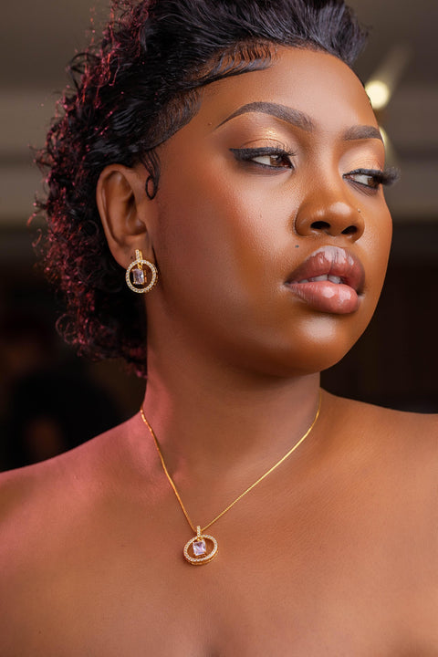 Woman wearing gold jewelry with a blurred background