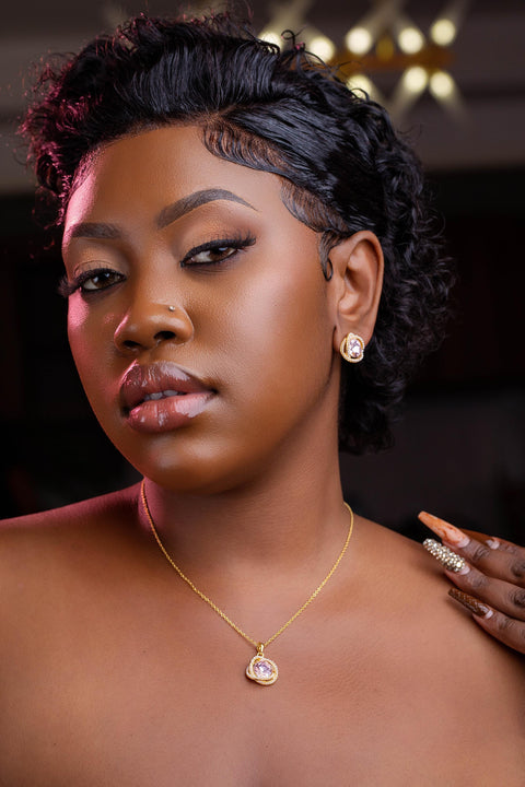 Woman with styled hair and jewelry against a dark background